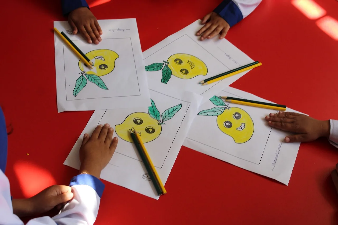 Young students colouring and learning together